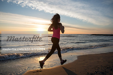 Young Girl Running On The Beach
