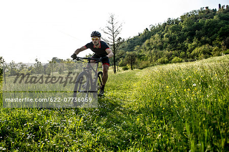 Man riding mountain bike in nature in the Bologna countryside, Italy