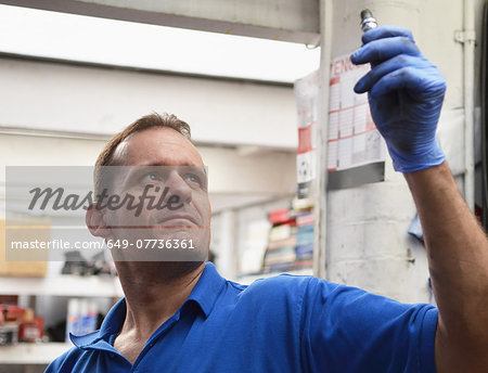 Mechanic checking spark plug