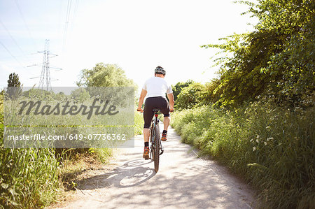 Cyclist cycling on path