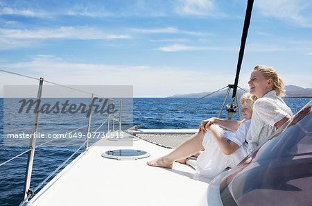 Mid adult mother son sailing on catamaran near Fuerteventura, Spain
