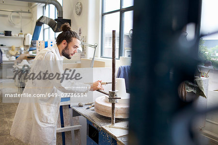 Male potter working in ceramic workshop