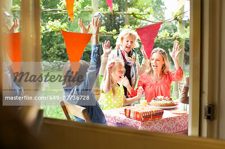 Family singing and cheering at birthday party