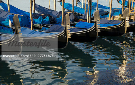 Close up of a row of gondolas on canal, Venice, Veneto, Italy