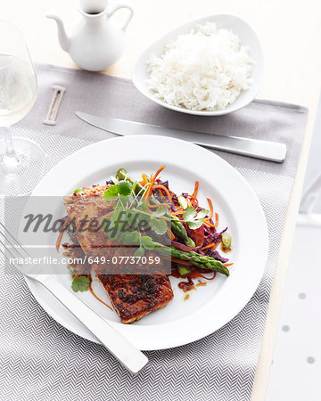 Plate of salmon lemongrass and asparagus with bowl of steamed rice