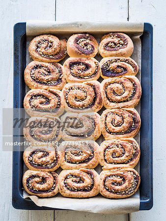 Freshly baked cinnamon rolls on a baking tray