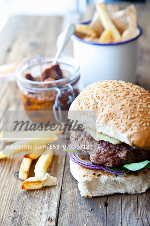 A homemade cheeseburger with watercress and chips