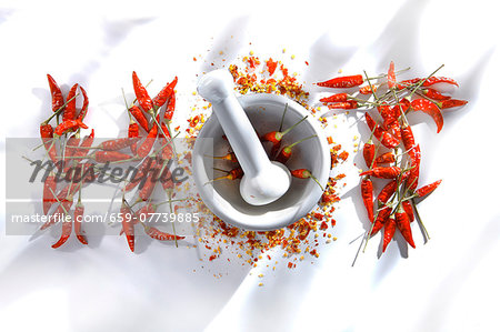 Red chilli peppers with a mortar