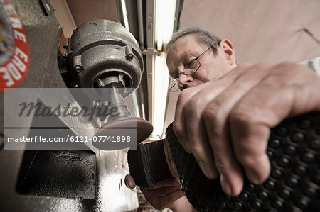 Cobbler working in workshop, close-up Cobbler working in workshop, close-up