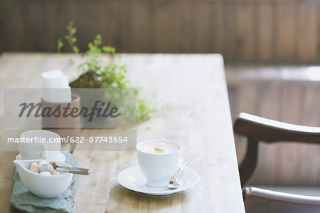 Cappuccino on wooden table in a cafe Cappuccino on wooden table in a cafe