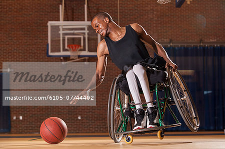 Man who had Spinal Meningitis in wheelchair reaching for basketball