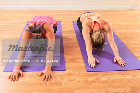 Young women with a spinal cord injuries doing a yoga poses in a studio