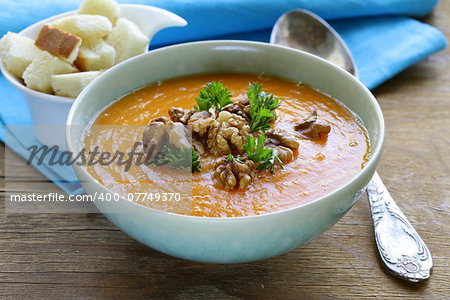 vegetable pumpkin cream soup with walnuts and parsley