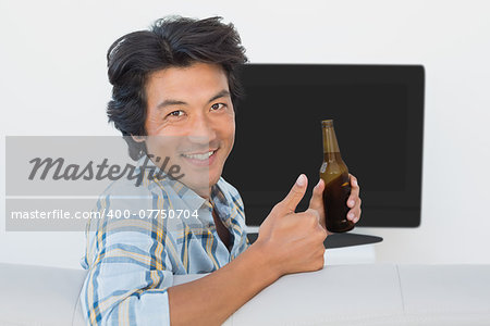 Portrait of a soccer fan watching tv
