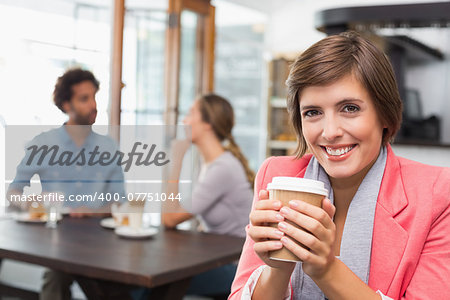 Pretty brunette enjoying her coffee at the coffee shop