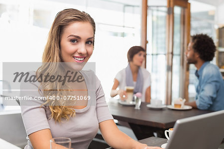 Pretty blonde using her laptop at the coffee shop