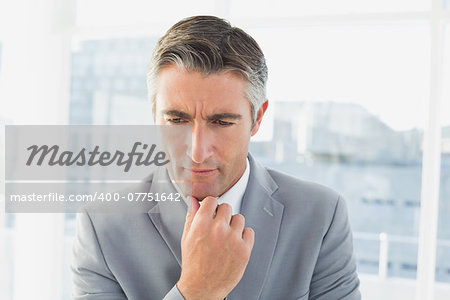 Businessman thinking about his work while in his office