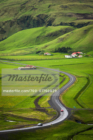 Scenic overview of farmland with winding road in spring, Vik, Iceland