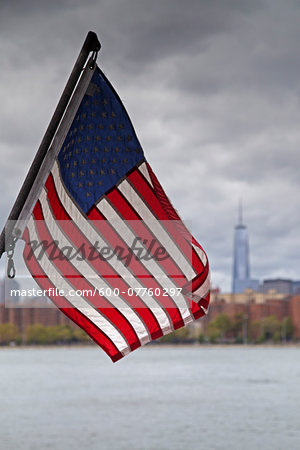 American Flag with New York City Skyline and East River in the background, New York, USA