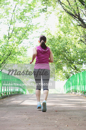 Young Japanese girl running in the park
