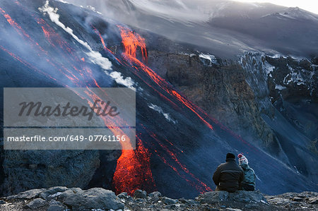 Couple watching volcanic lava, Fimmvorduhals, Iceland