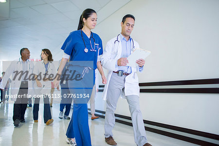 Doctor and nurse reading medical chart in hospital