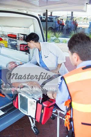 Doctor examining patient on ambulance stretcher Doctor examining patient on ambulance stretcher
