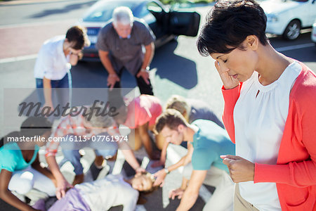 Woman calling emergency services at car accident