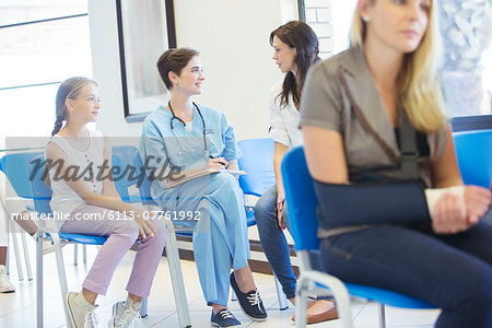 Nurse and patients talking in hospital