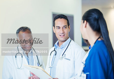Doctors and nurse talking in hospital hallway
