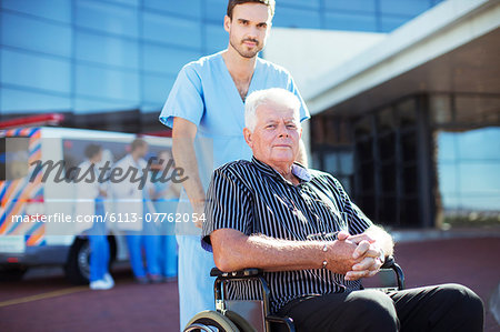 Nurse wheeling patient outside hospital