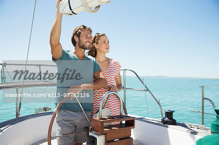 Couple steering boat together