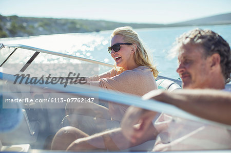 Couple driving boat in water
