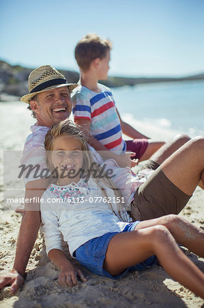 Family sitting in sand together