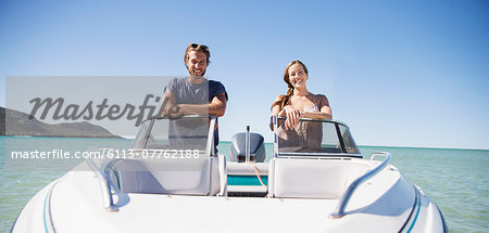 Couple standing in boat on water Couple standing in boat on water