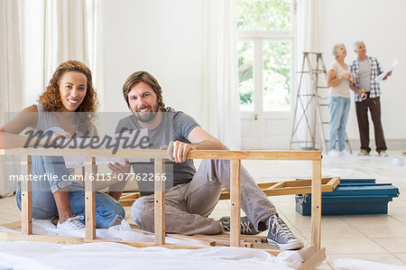Couple building furniture together