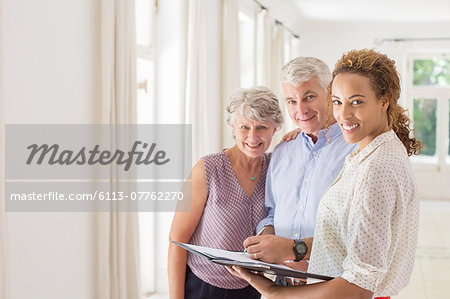 Older couple and woman signing documents