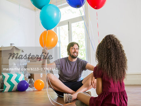 Father and daughter playing with balloons