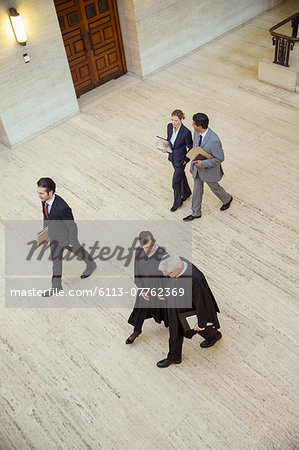 Judges and lawyer walking through courthouse