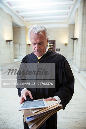 Judge using digital tablet in courthouse