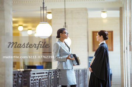 Judge and lawyer talking in courthouse