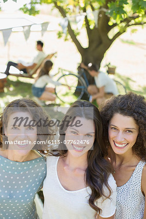 Three women hugging outdoors