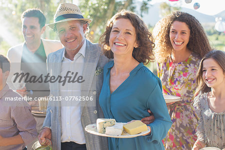 Older couple hugging at family picnic Older couple hugging at family picnic