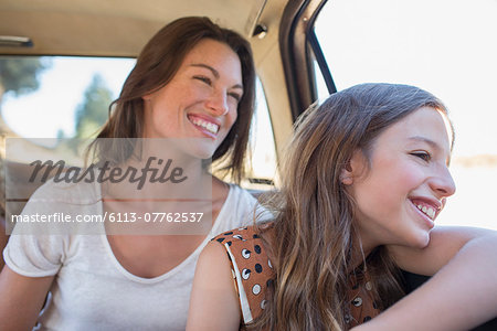 Sisters riding in car backseat together