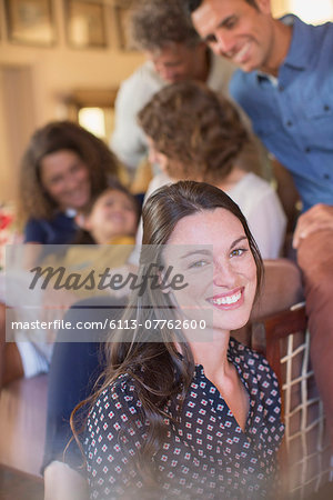 Woman smiling in living space with family