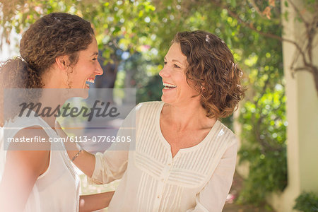 Mother and daughter laughing together