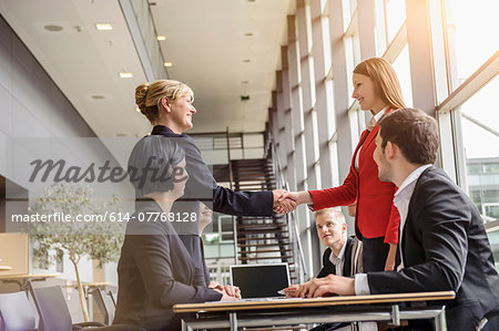 Businesswoman and team meeting client