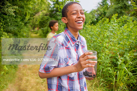 Teenage boys picking berries