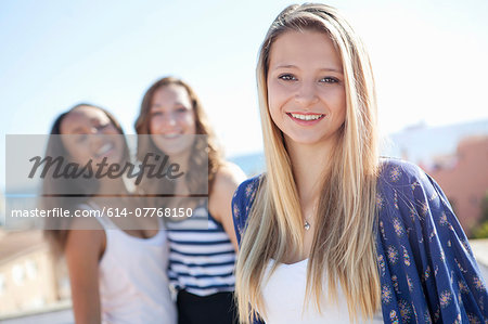 Teenage girl, friends in background