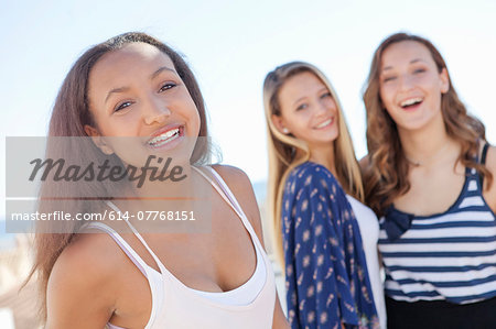 Teenage girl, friends in background